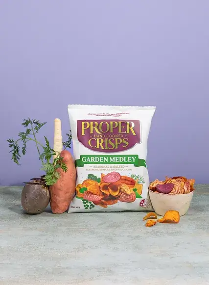 garden medley lifestyle image with real vegetable on the side of the bag of crisps